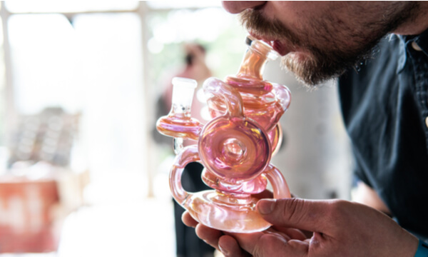 Closeup of a man smoking a bong 